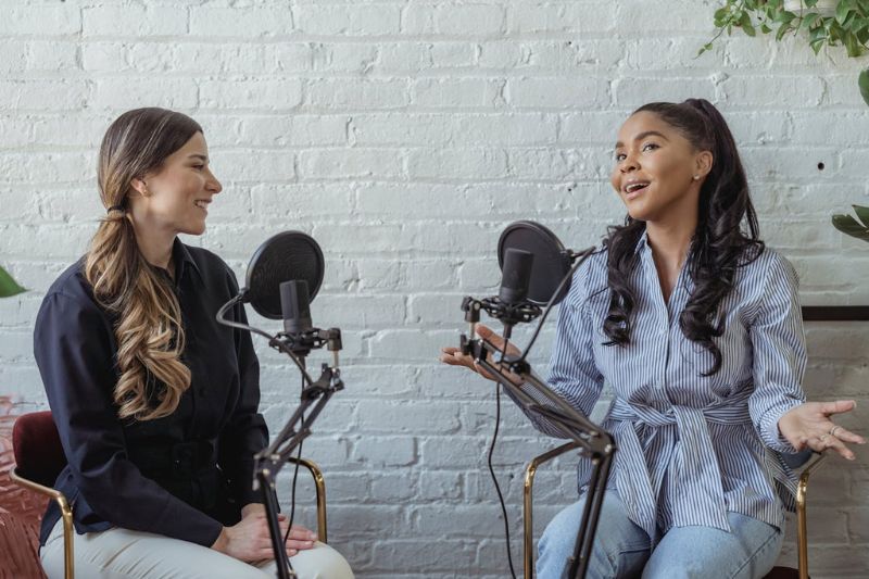 two women talking to microphones